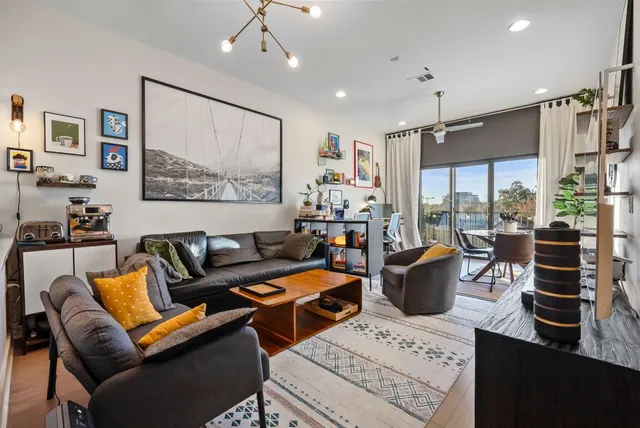 a living room with furniture a large window and a view of living room