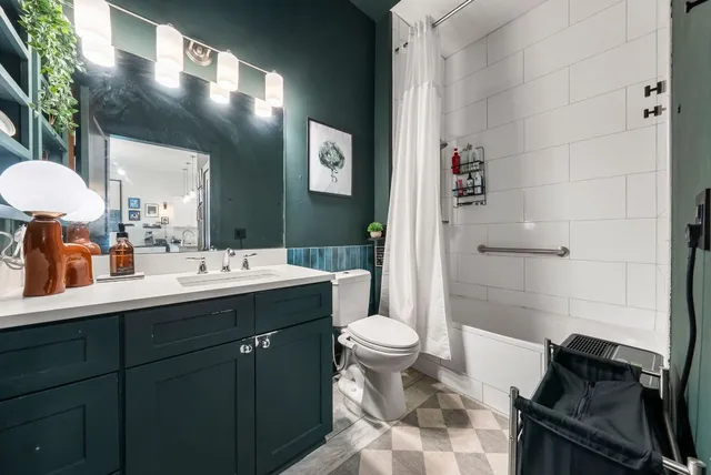 a bathroom with a sink toilet and shower