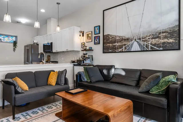 a living room with furniture and wall paintings