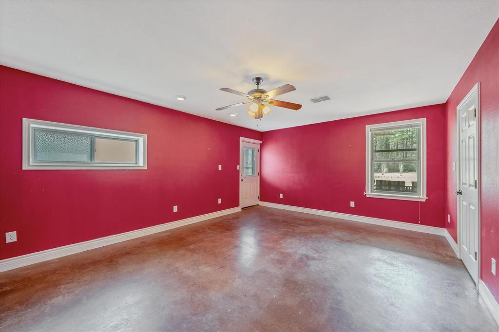 1070 Piney Grove Road Rusk, TX 75785 - Photo 15 of 39 Unfurnished room with finished concrete flooring and ceiling fan