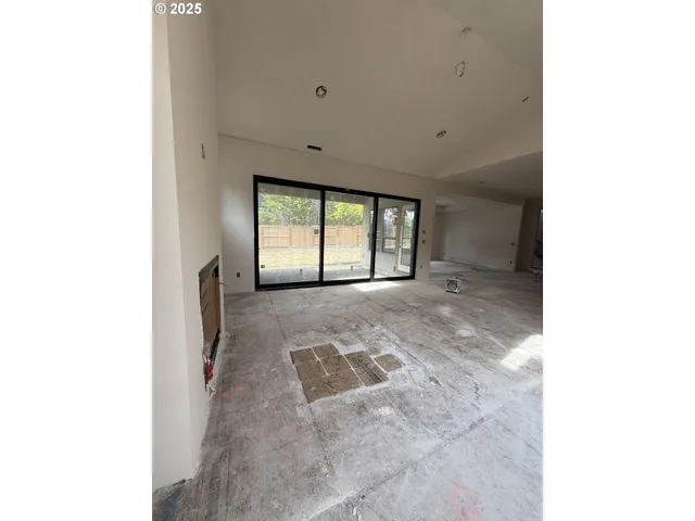 a view of an empty room with a fireplace