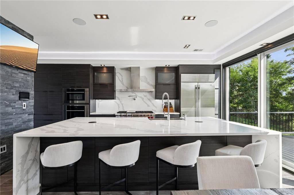 646 Science Street Pittsburgh, PA 15210 - Photo 5 of 35 This true culinary haven is as functional as it is breathtaking. Calacatta Quartz backsplash and countertops with dramatic waterfall edges create a seamless, luxurious aesthetic. Outfitted with professional-grade stainless steel appliances—including Wolf, Sub-Zero, and Miele—this kitchen is ready to meet the needs of any chef.