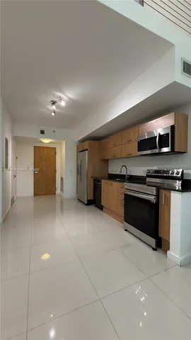 a kitchen with granite countertop a stove and cabinets