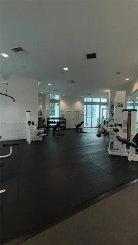 a view of a room with gym equipment and a large window