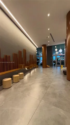 a lobby with furniture and a rug