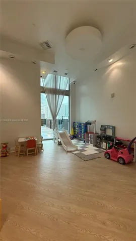 a view of a room with gym equipment and a large window