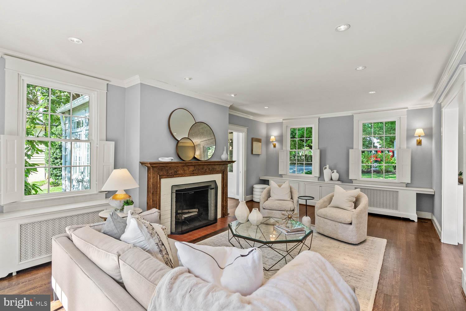 7406 Brookville Road Chevy Chase, MD 20815 - Photo 12 of 72 a living room with furniture a fireplace and a large window