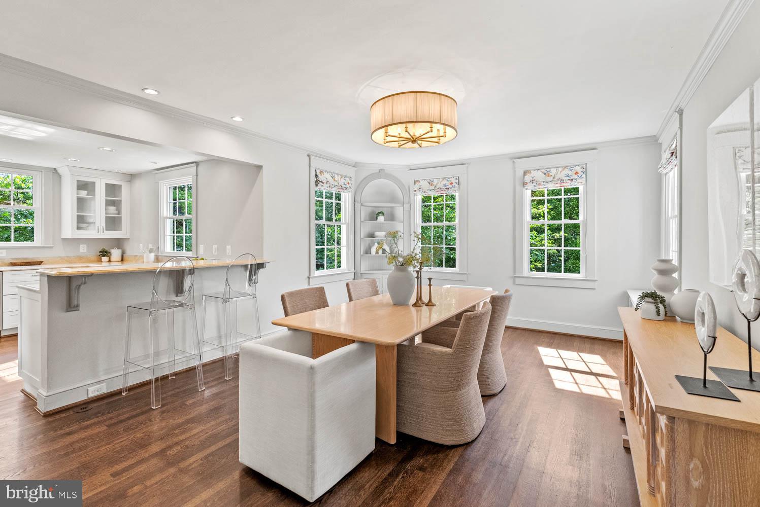 7406 Brookville Road Chevy Chase, MD 20815 - Photo 16 of 72 a dining room with wooden floor and a chandelier