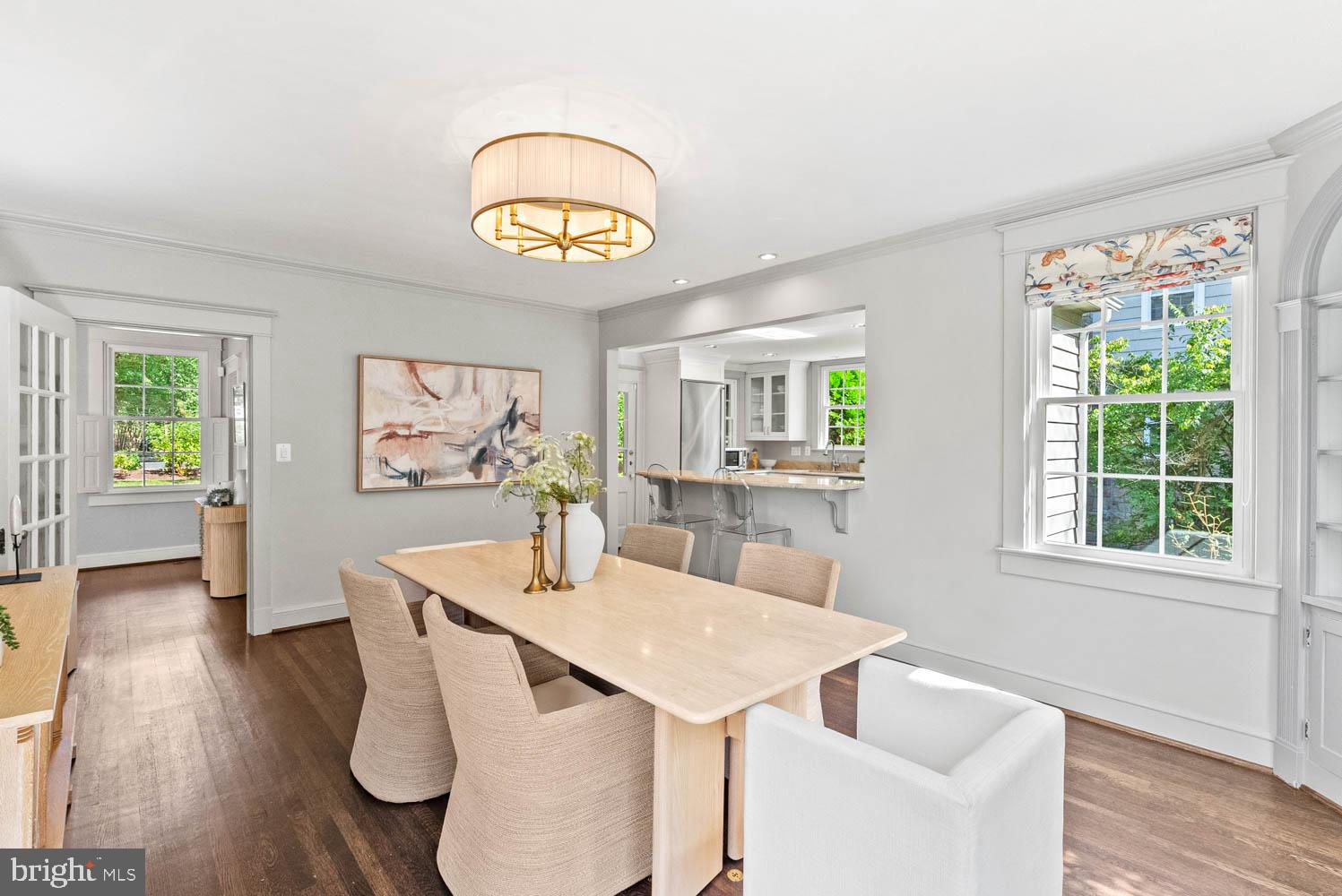 7406 Brookville Road Chevy Chase, MD 20815 - Photo 18 of 72 a view of a dining room with furniture a chandelier and wooden floor