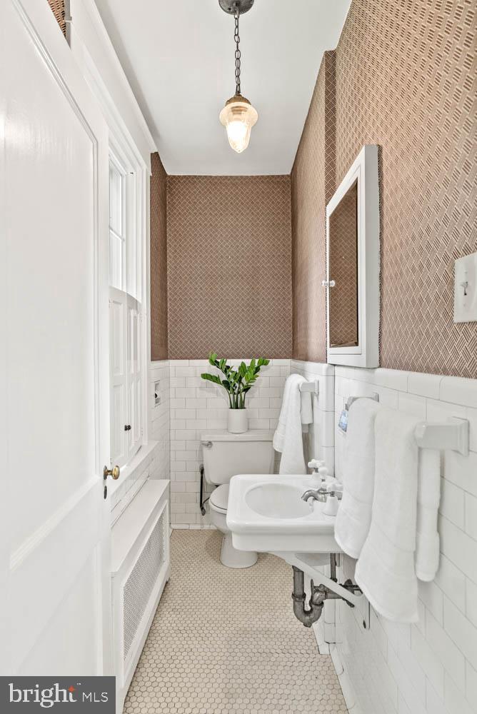 7406 Brookville Road Chevy Chase, MD 20815 - Photo 24 of 72 a bathroom with a sink a toilet and a mirror