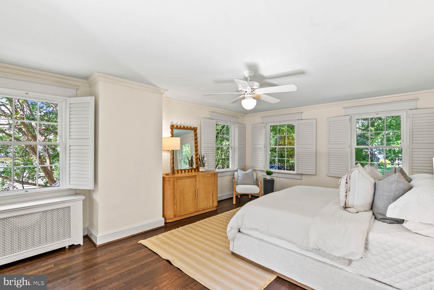 7406 Brookville Road Chevy Chase, MD 20815 - Photo 28 of 72 a large bedroom with wooden floor and large window
