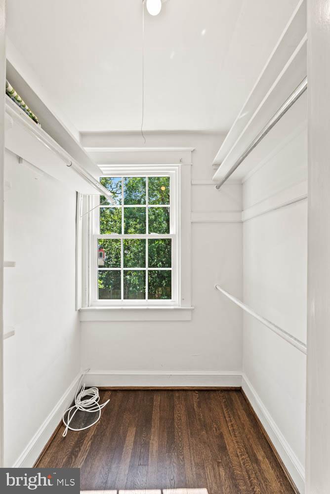 7406 Brookville Road Chevy Chase, MD 20815 - Photo 32 of 72 an empty room with wooden floor and windows