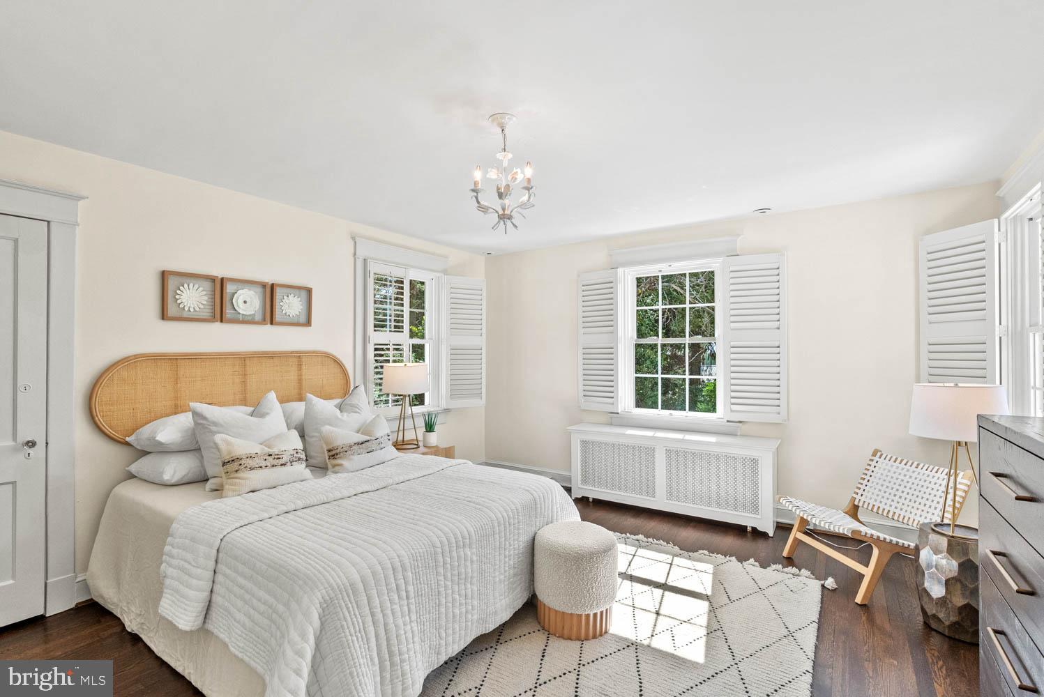 7406 Brookville Road Chevy Chase, MD 20815 - Photo 34 of 72 a bedroom with a bed and wooden floor