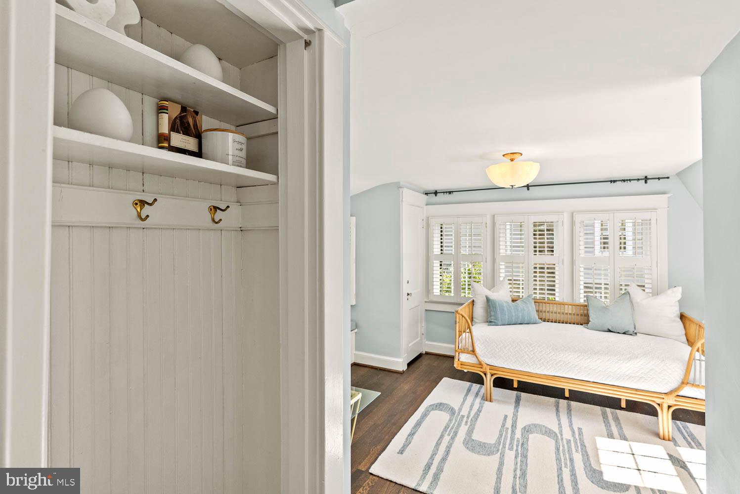 7406 Brookville Road Chevy Chase, MD 20815 - Photo 38 of 72 a living room with furniture a rug and a window