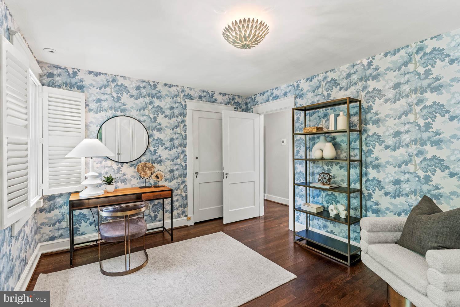7406 Brookville Road Chevy Chase, MD 20815 - Photo 42 of 72 a living room with furniture a rug and a chandelier