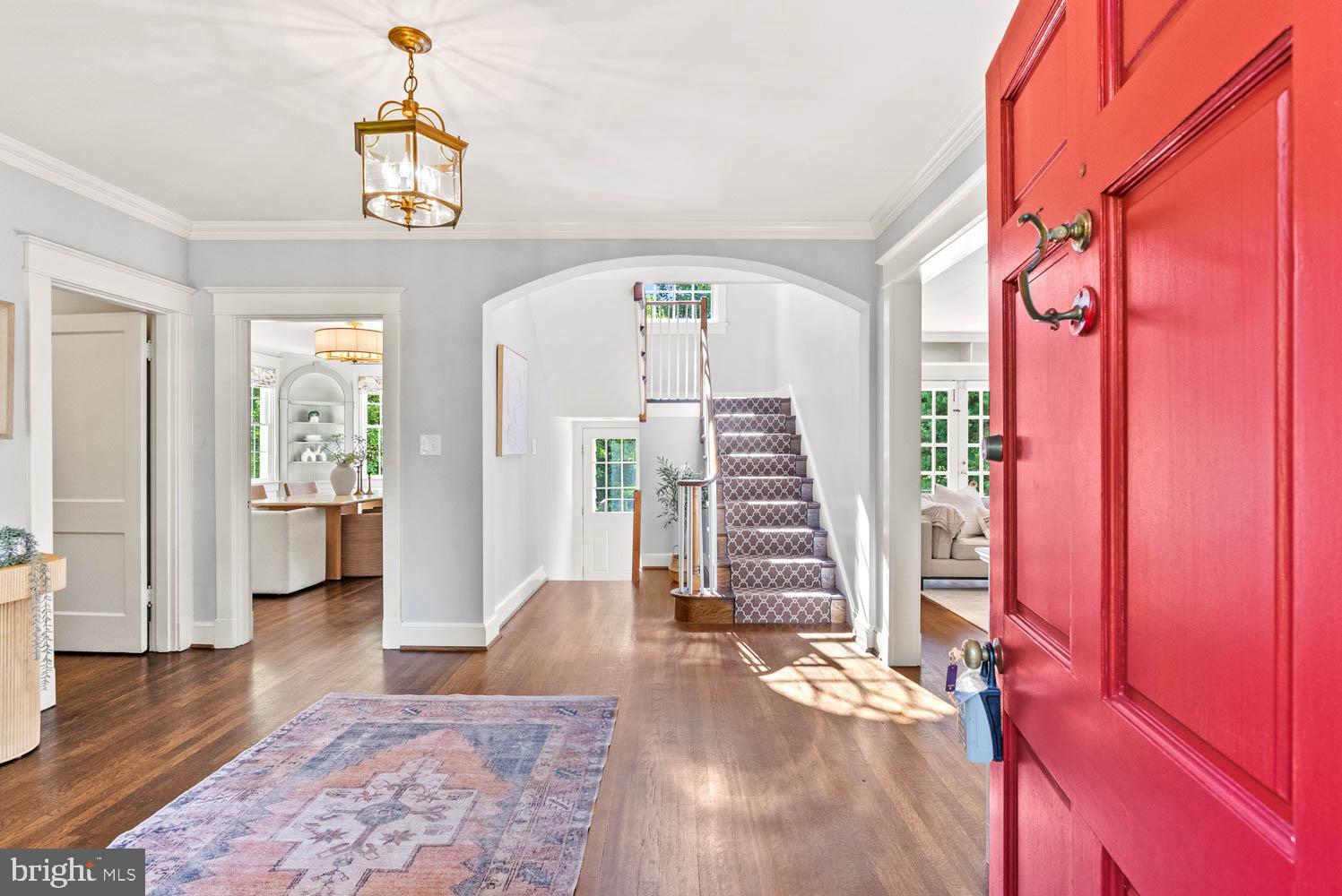 7406 Brookville Road Chevy Chase, MD 20815 - Photo 5 of 72 a view of an entryway with wooden floor and stairs