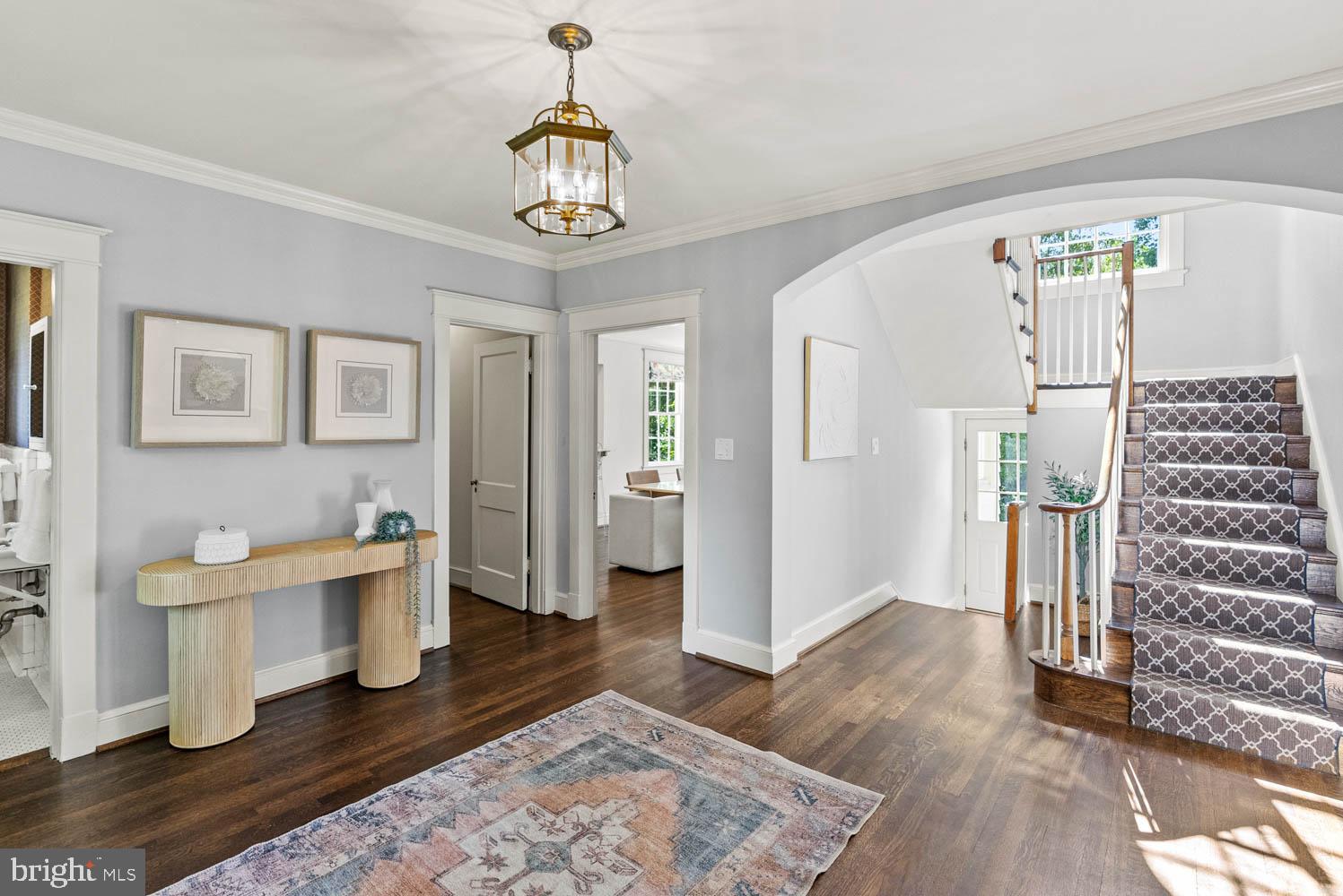 7406 Brookville Road Chevy Chase, MD 20815 - Photo 7 of 72 a view of a livingroom with furniture wooden floor and a chandelier