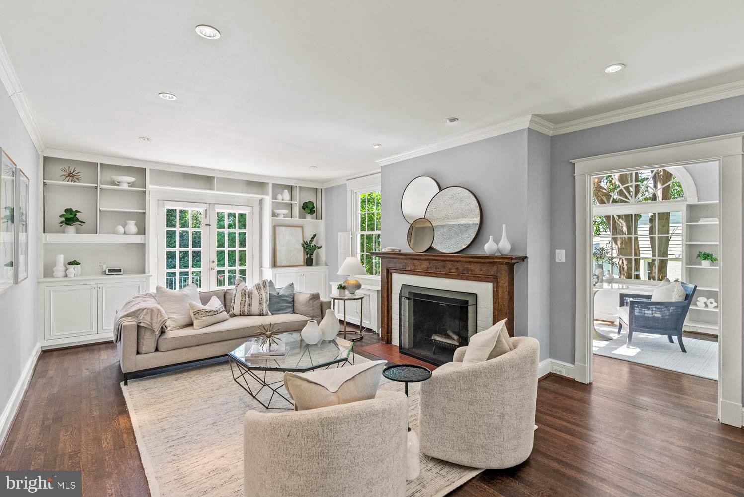 7406 Brookville Road Chevy Chase, MD 20815 - Photo 10 of 72 a living room with furniture a fireplace and a large window