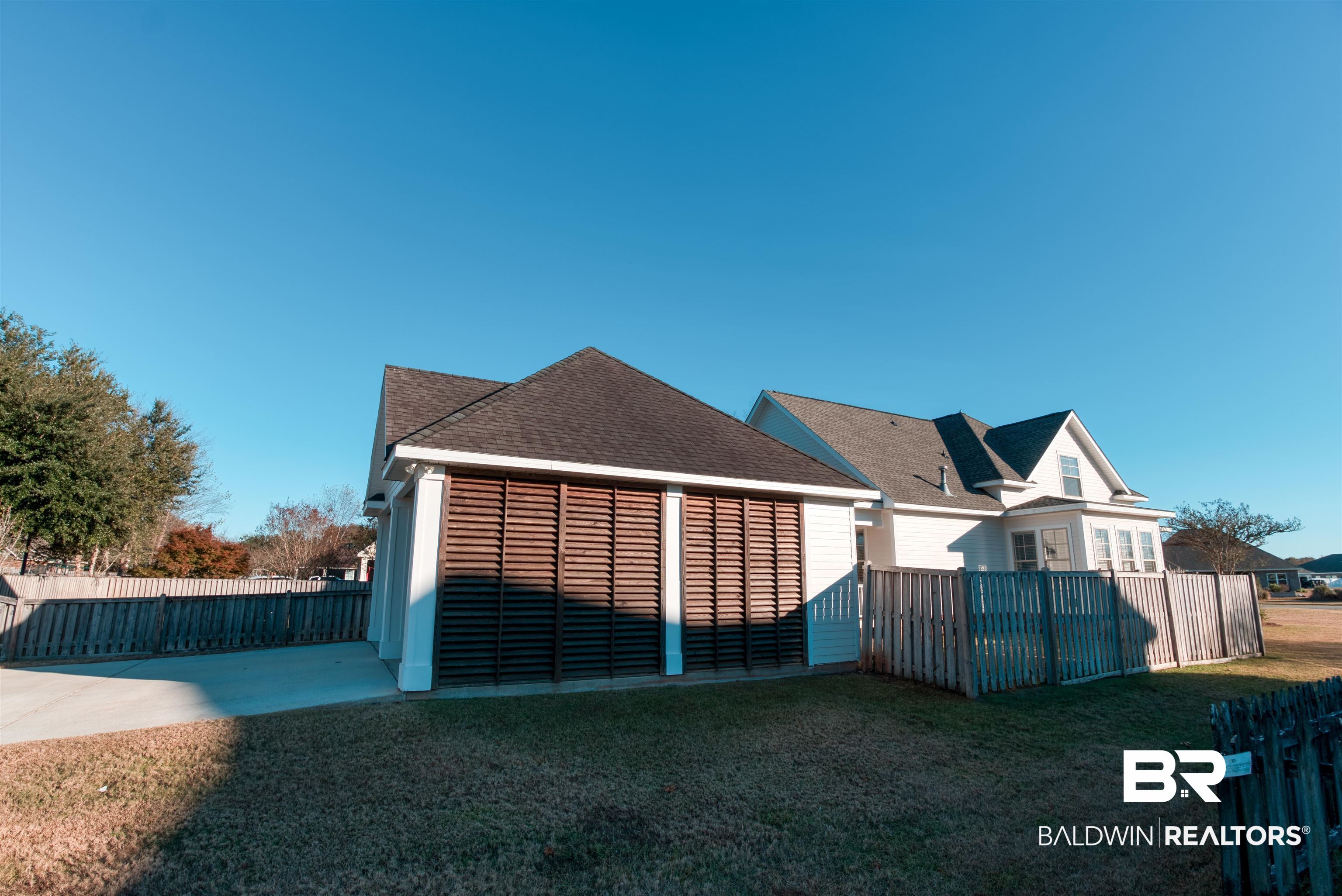 24561 Austin Road Daphne, AL 36526 - Photo 46 of 57 Rear view of house with a patio and a lawn