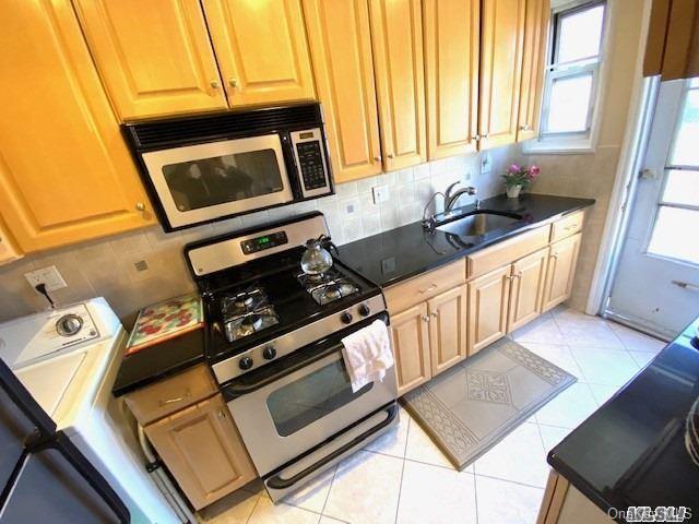 a kitchen with a stove and a microwave