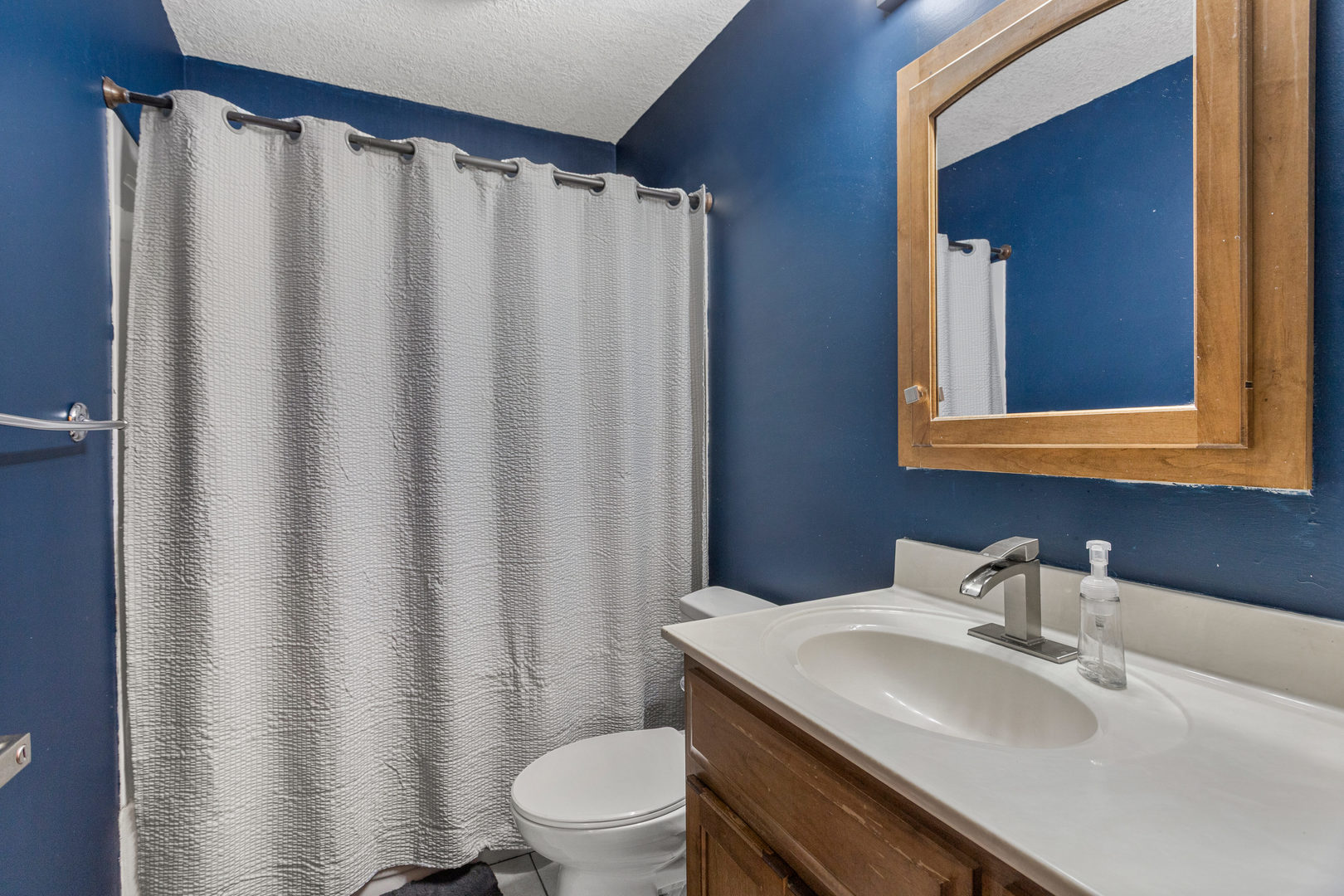 1351 West Pershing Road Decatur, IL 62526 - Photo 16 of 24 a bathroom with a sink toilet and mirror