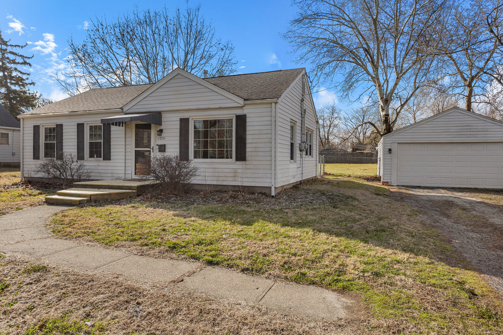 1351 West Pershing Road Decatur, IL 62526 - Photo 3 of 24 a front view of a house with a yard