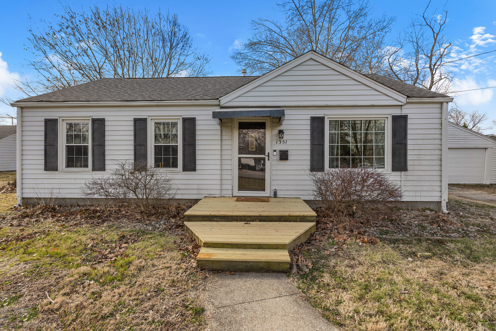 1351 West Pershing Road Decatur, IL 62526 - Photo 5 of 24 front view of a house with a large window and potted plants