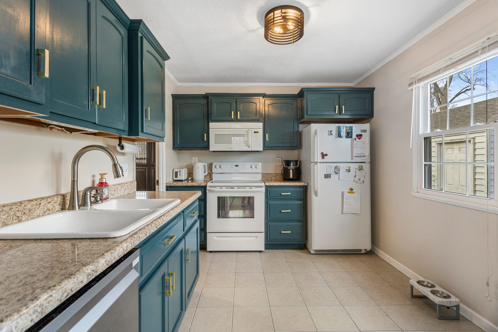 1351 West Pershing Road Decatur, IL 62526 - Photo 9 of 24 a kitchen with stainless steel appliances granite countertop a sink stove and refrigerator