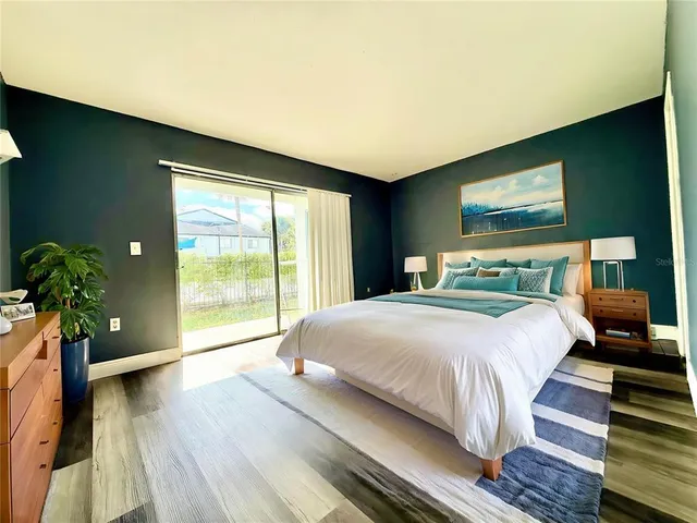 a bedroom with a large bed and a large window