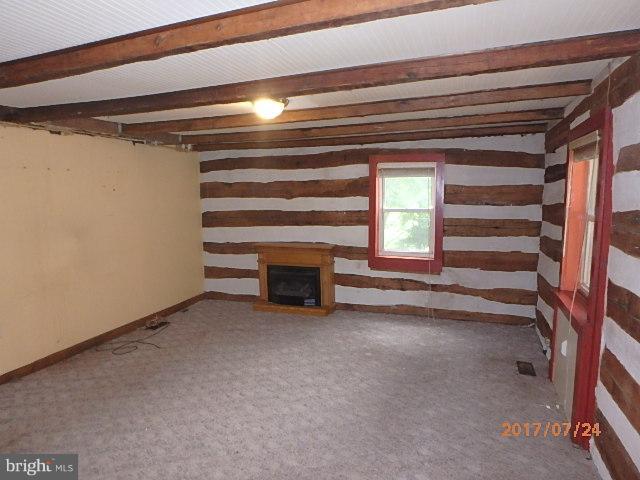 4709 Elmer Derr Road Frederick, MD 21703 - Photo 3 of 10 a view of an empty room with a fireplace and a window