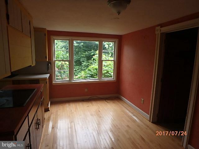 4709 Elmer Derr Road Frederick, MD 21703 - Photo 4 of 10 an empty room with wooden floor and windows
