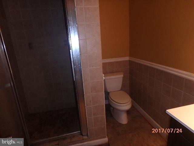 4709 Elmer Derr Road Frederick, MD 21703 - Photo 7 of 10 a white toilet sitting next to a shower