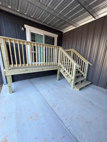 a view of a backyard with wooden fence