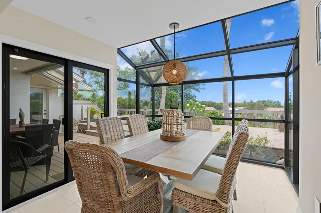 a view of a dining room with furniture large windows and wooden floor
