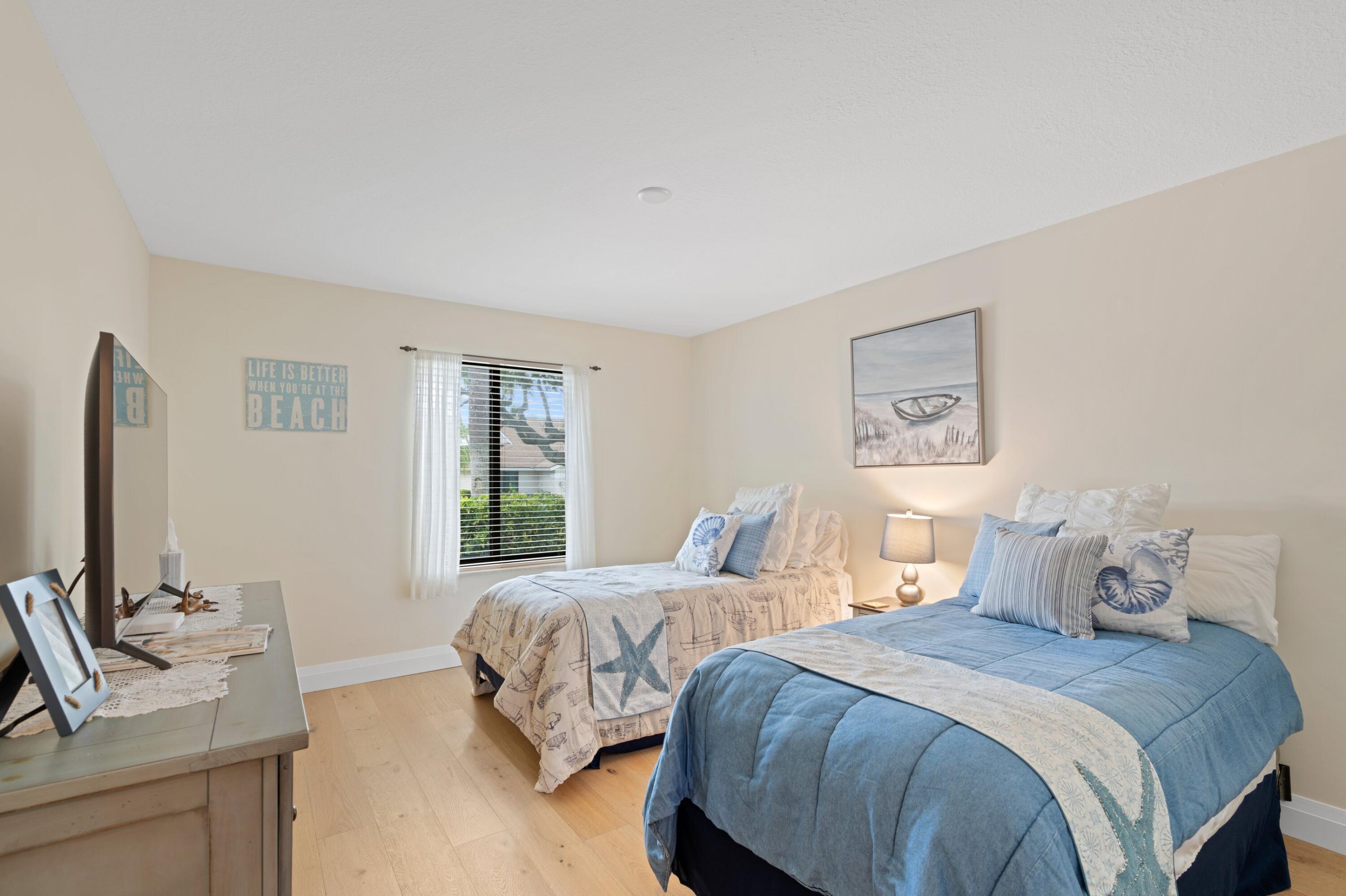 197 Ridge Road Jupiter, FL 33477 - Photo 25 of 44 a bedroom with two beds and a couch