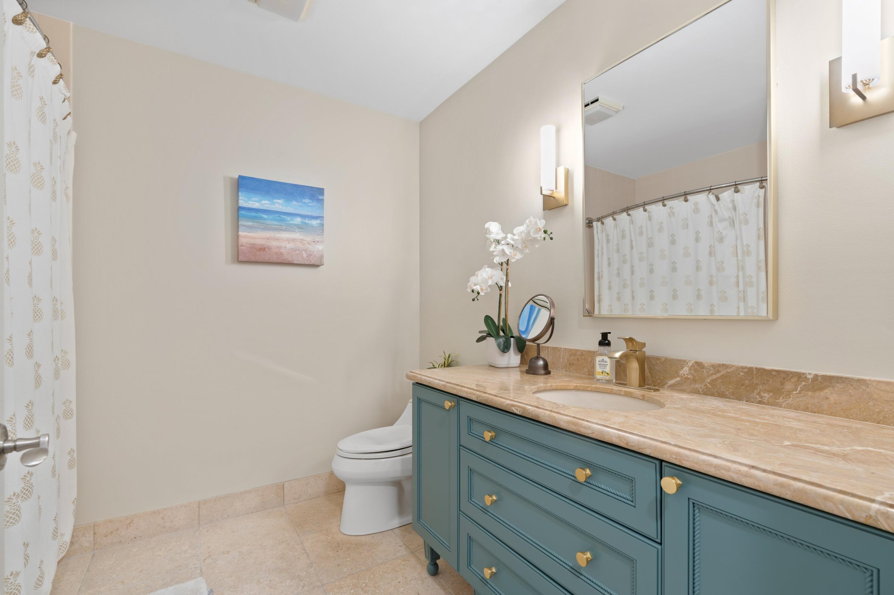197 Ridge Road Jupiter, FL 33477 - Photo 27 of 44 a bathroom with a granite countertop toilet sink and mirror