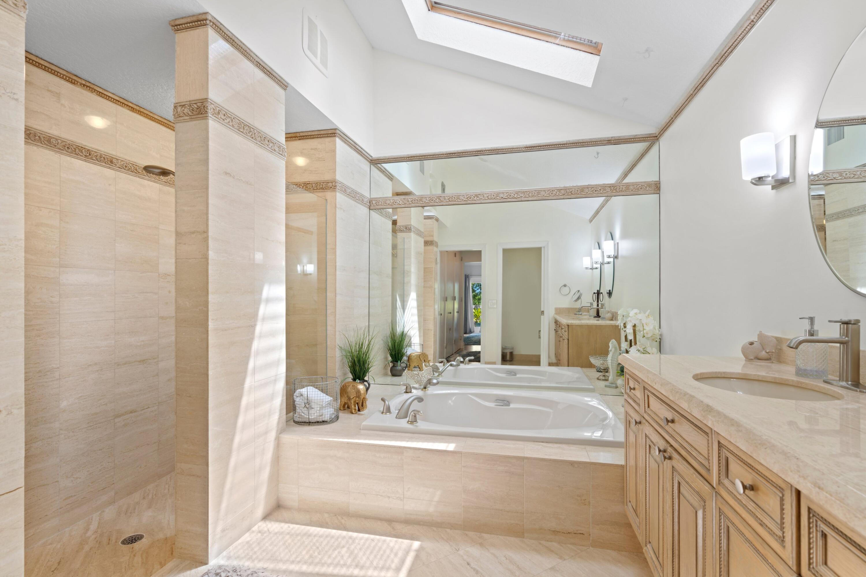 197 Ridge Road Jupiter, FL 33477 - Photo 30 of 44 a spacious bathroom with a granite countertop sink a mirror and a shower