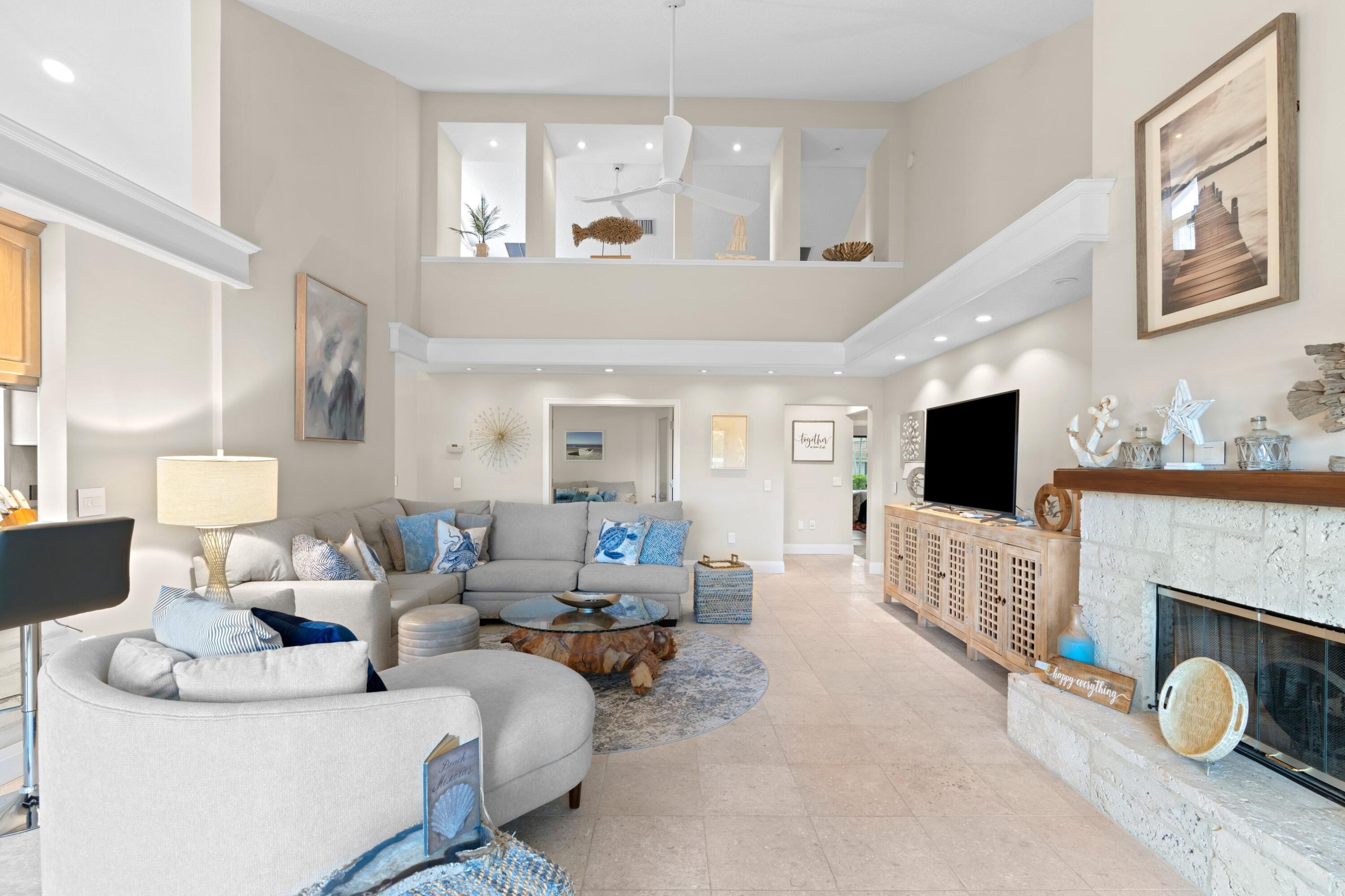 197 Ridge Road Jupiter, FL 33477 - Photo 31 of 44 a living room with furniture a flat screen tv and a fireplace