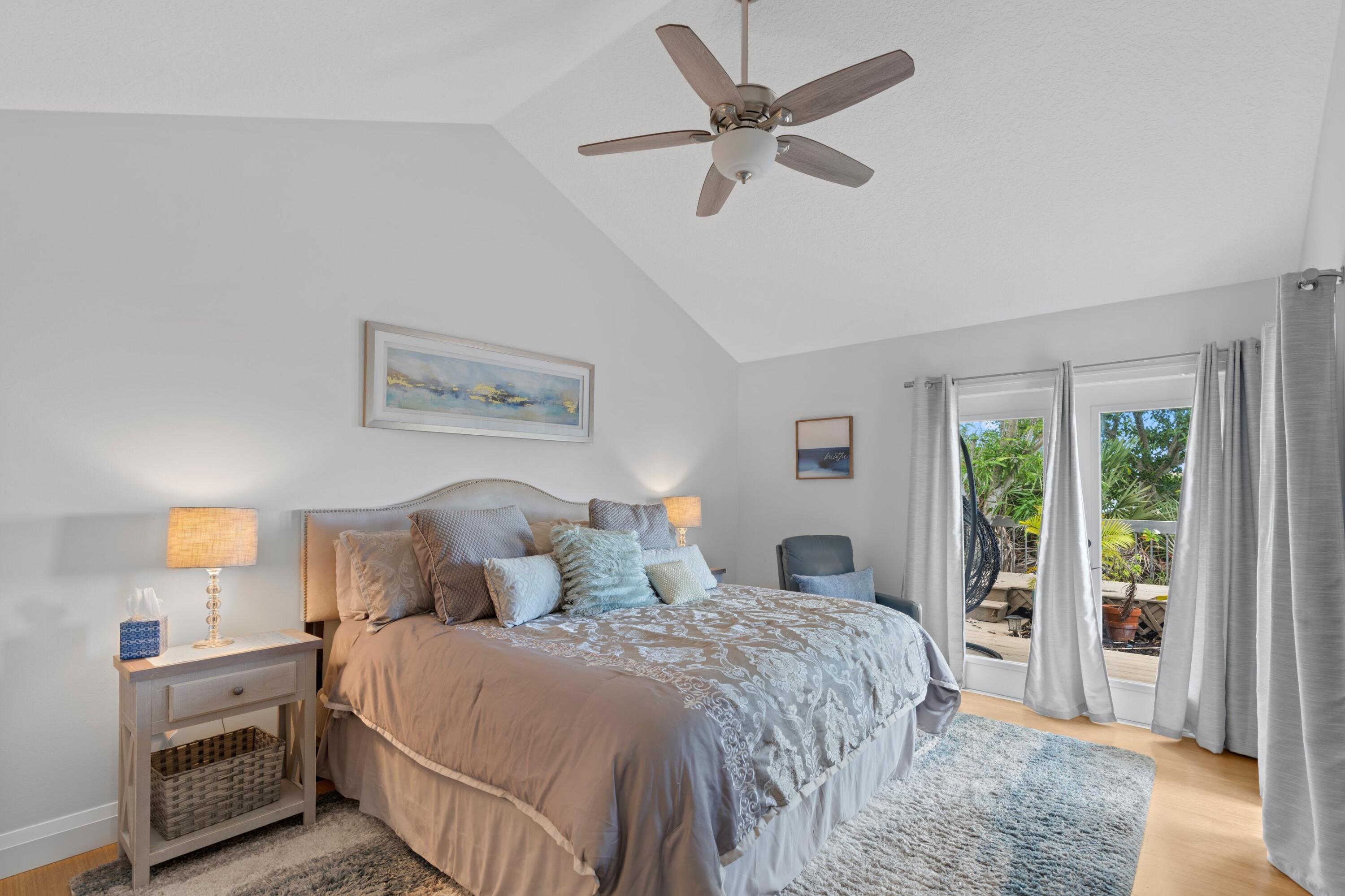 197 Ridge Road Jupiter, FL 33477 - Photo 34 of 44 a bedroom with a large bed and a chandelier