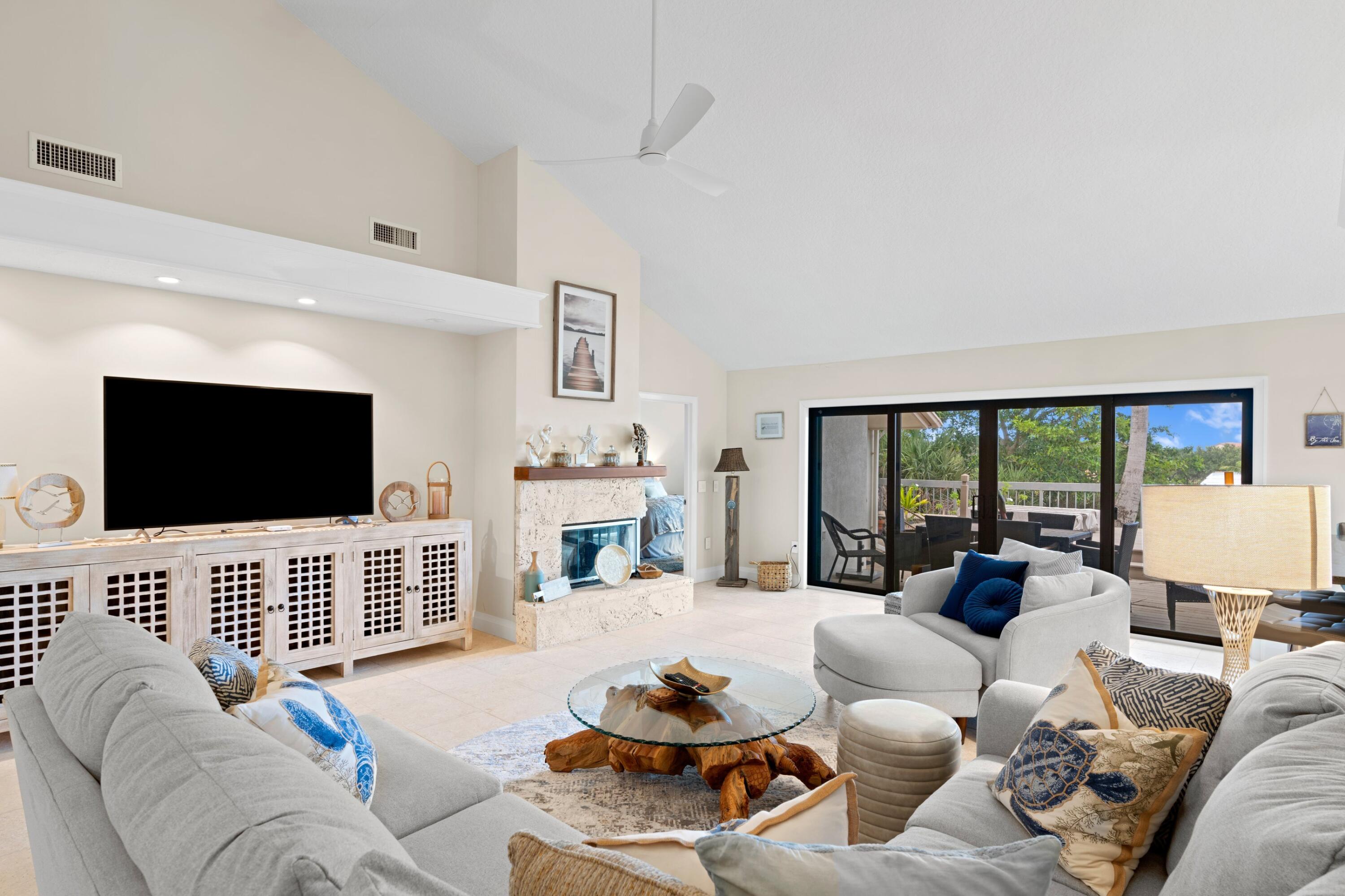 197 Ridge Road Jupiter, FL 33477 - Photo 40 of 44 a living room with furniture a flat screen tv and a large window