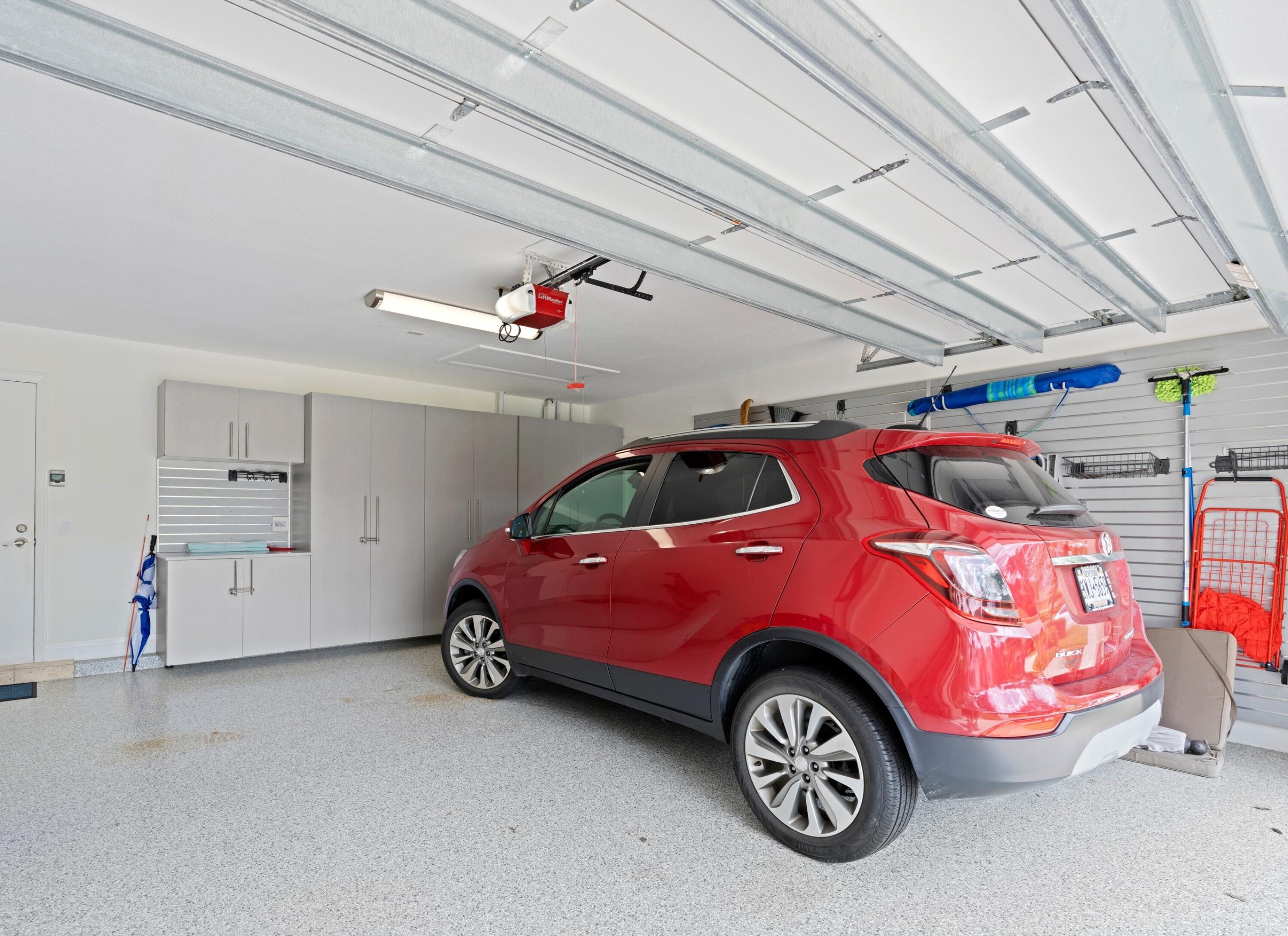 197 Ridge Road Jupiter, FL 33477 - Photo 44 of 44 a blue car parked in a garage