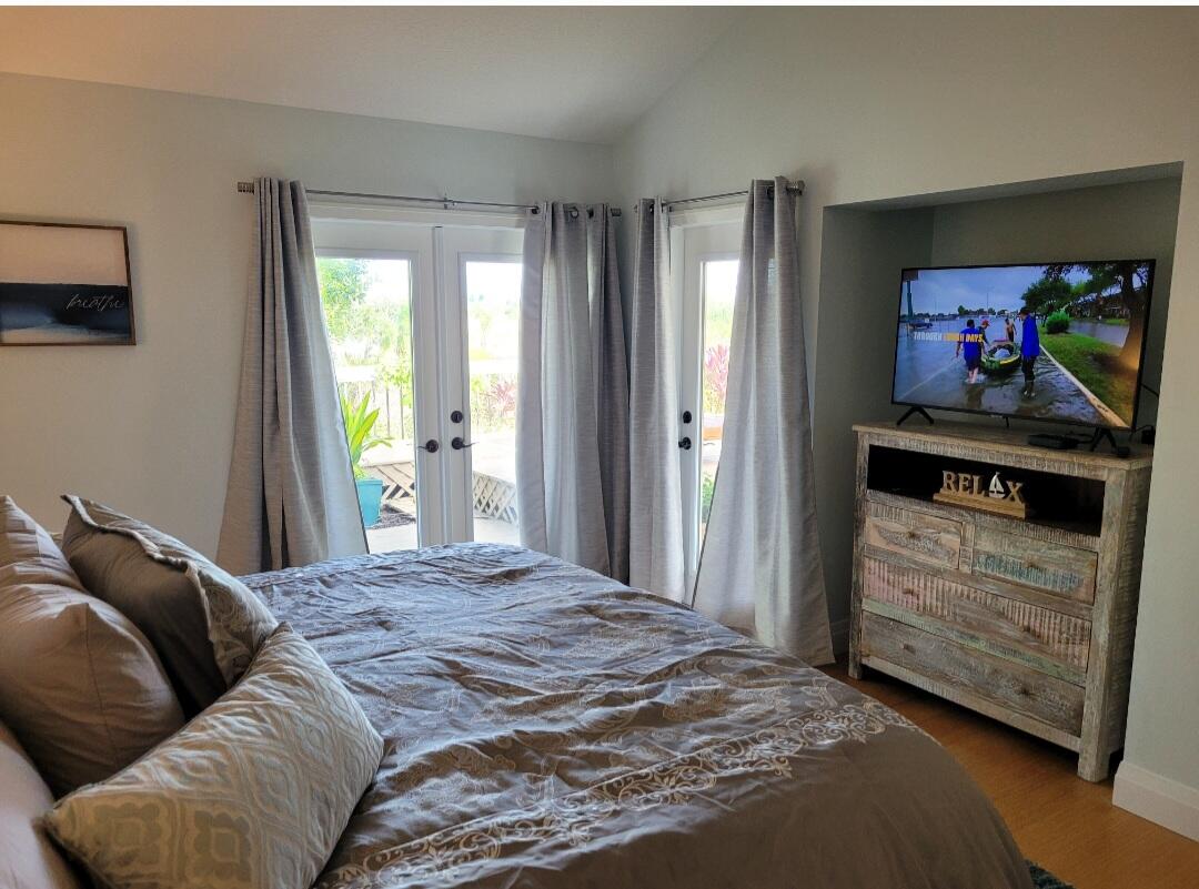 197 Ridge Road Jupiter, FL 33477 - Photo 5 of 44 a bedroom with a bed and a dresser