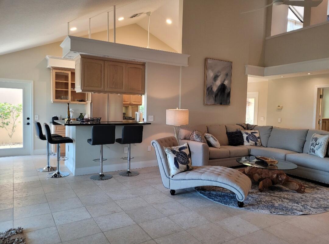 197 Ridge Road Jupiter, FL 33477 - Photo 7 of 44 a living room with furniture a lamp and a window