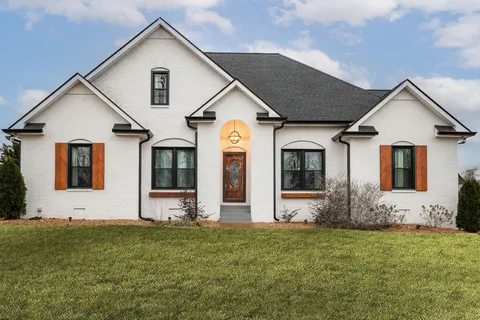 a front view of house with yard and green space