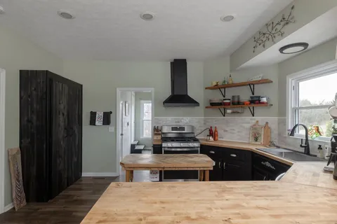 a kitchen with stainless steel appliances a stove a refrigerator and cabinets