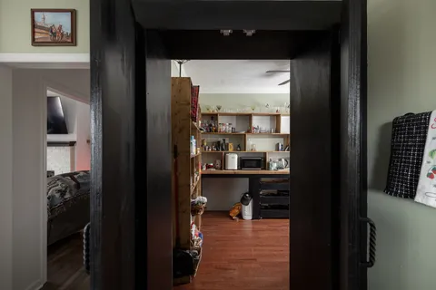 a living room with furniture and a wooden floor