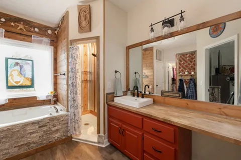 a view of a hallway with wooden floor and a window