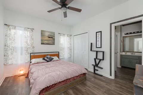 a bedroom with a bed and wooden floor