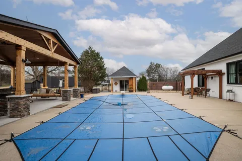 a view of a yard with trees in the background