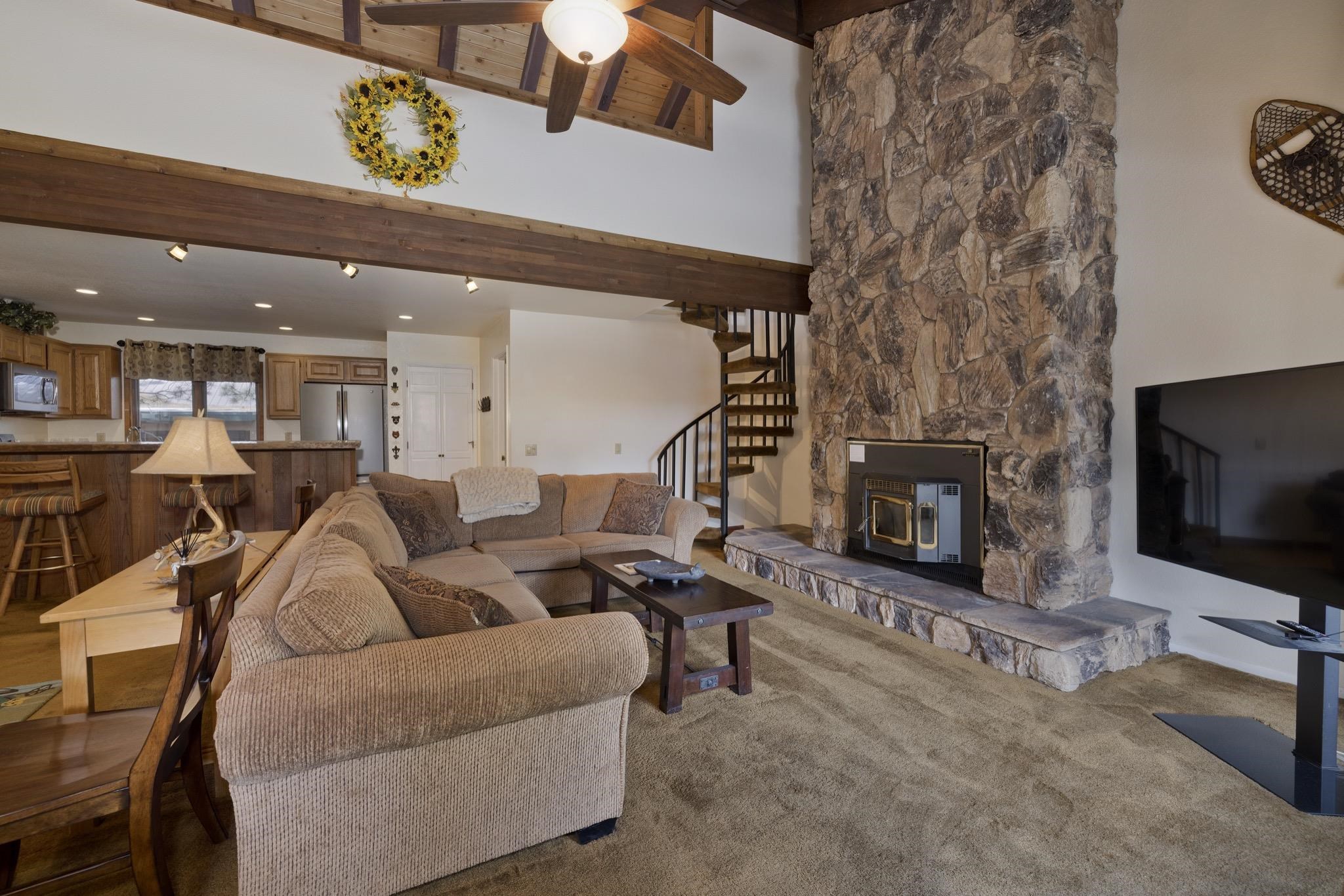 484 Manzanita Road, Unit 16 Mammoth Lakes, CA 93546 - Photo 8 of 34 a living room with furniture a fireplace and a flat screen tv